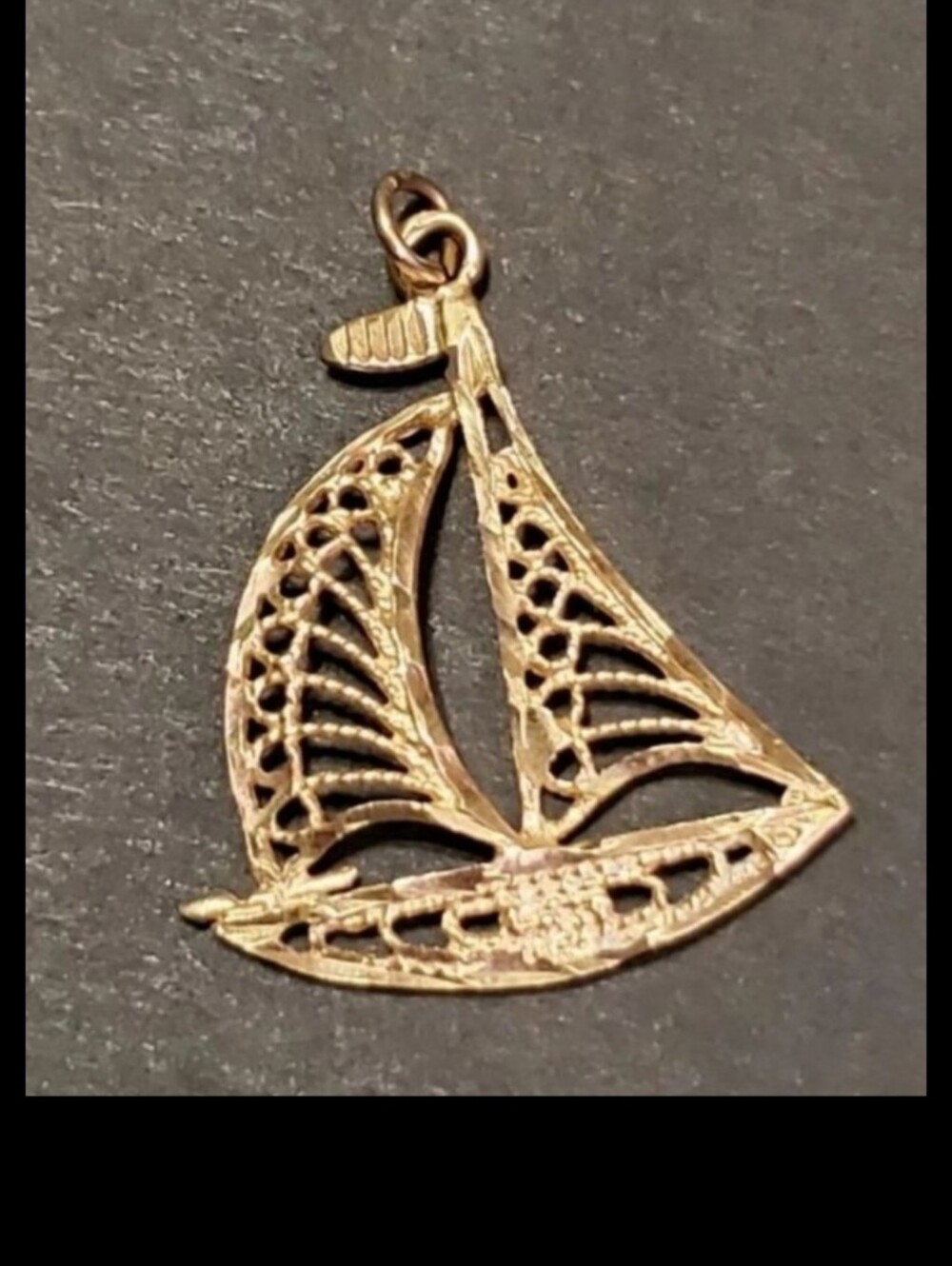 14k (stamped see pics) yellow gold Sailboat Pendant! This pendant has  alot of d
